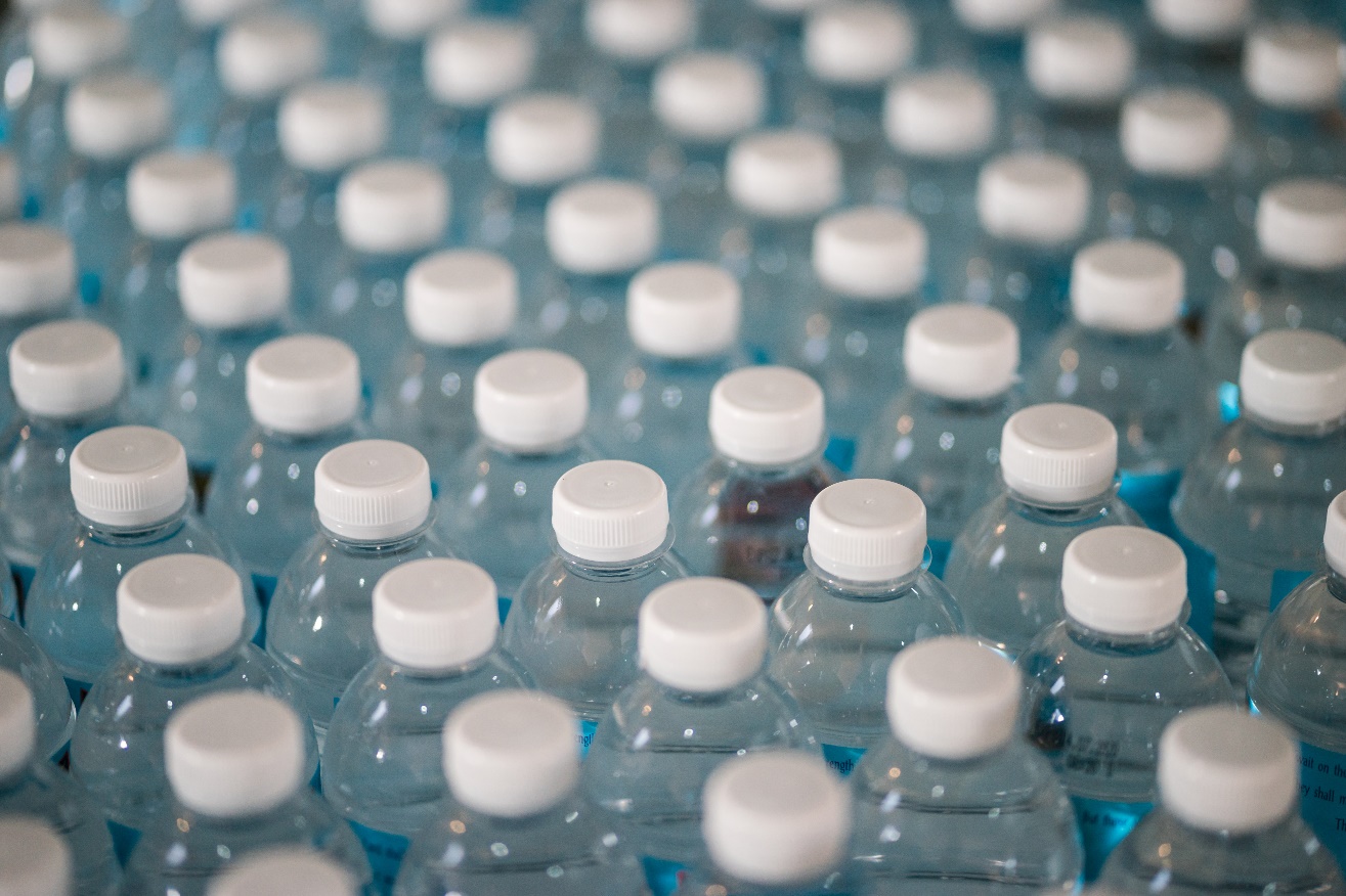 Rows of unopened plastic mineral water bottles. 