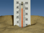 A thermometer standing in sand, showing 40 degrees C.