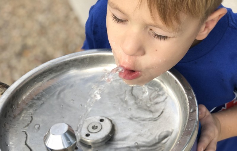 Child drinking from water fountain