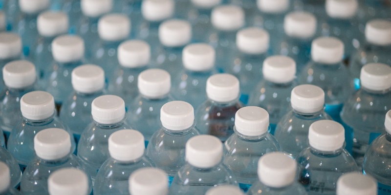 Rows of unopened plastic mineral water bottles. 