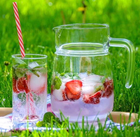 Glass and Jug filled with strawberry water