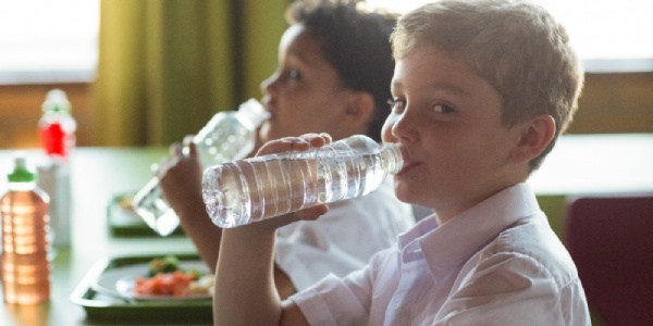 Children drinking water in school